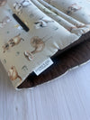 Close-up of Dark Chocolate 100% Linen & Sage Aussie Animals fabric on a pre-made Comfy Co. Size 1 pram liner.