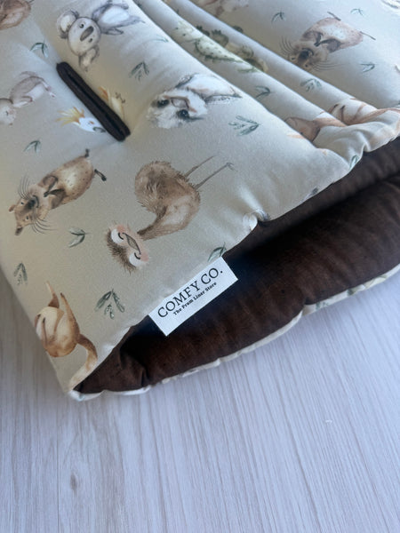 Close-up of Dark Chocolate 100% Linen & Sage Aussie Animals fabric on a pre-made Comfy Co. Size 1 pram liner.