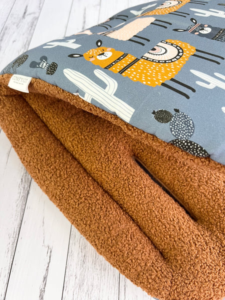 Close-up of Llamas and Toffee Bear fabric on a pre-made Comfy Co. Size 1 pram liner.
